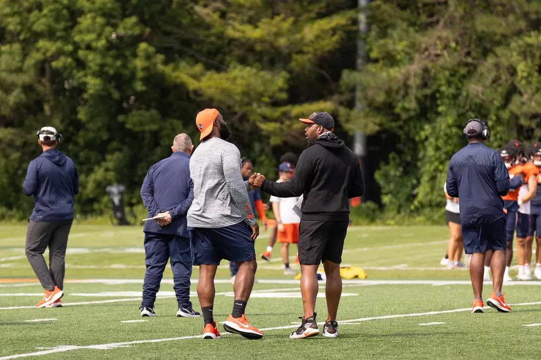 Fran 棕色（的） running onto the JMA Dome field with Syracuse Football players.